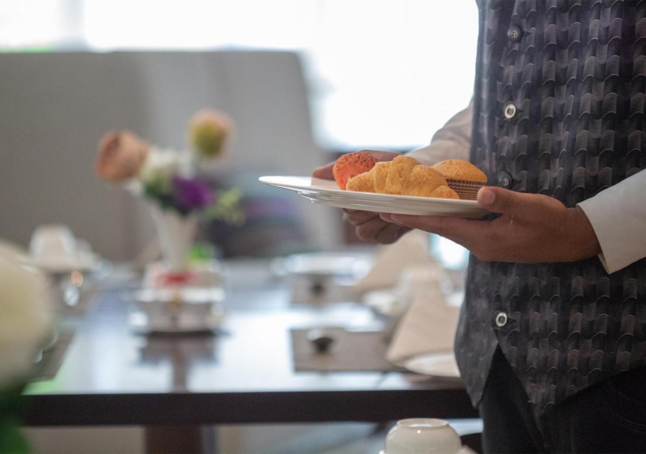 Holiday Suites Al Azizia Μέκκα Εξωτερικό φωτογραφία A waiter serving food at a buffet